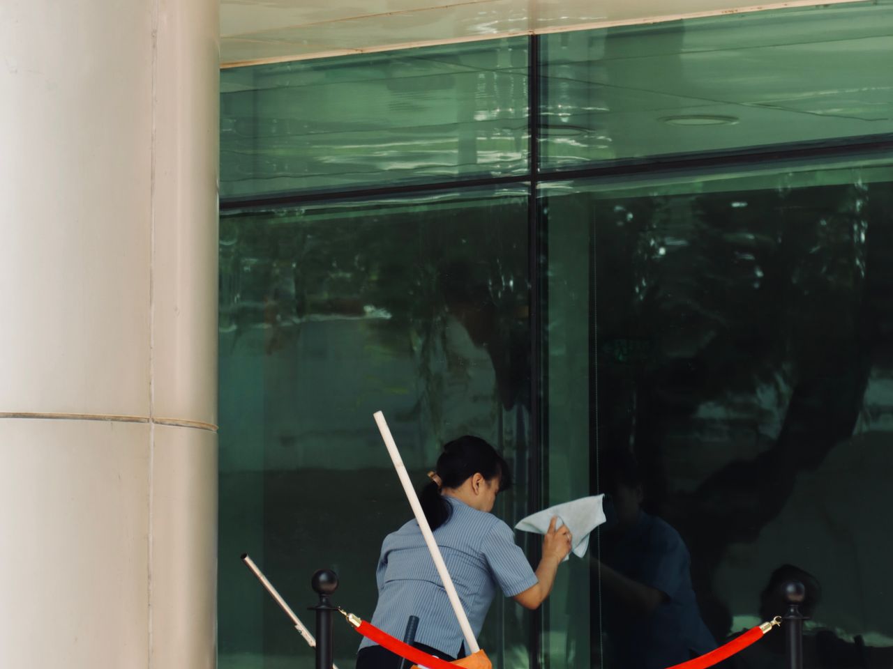 Worker cleaning the exterior windows of a commercial building